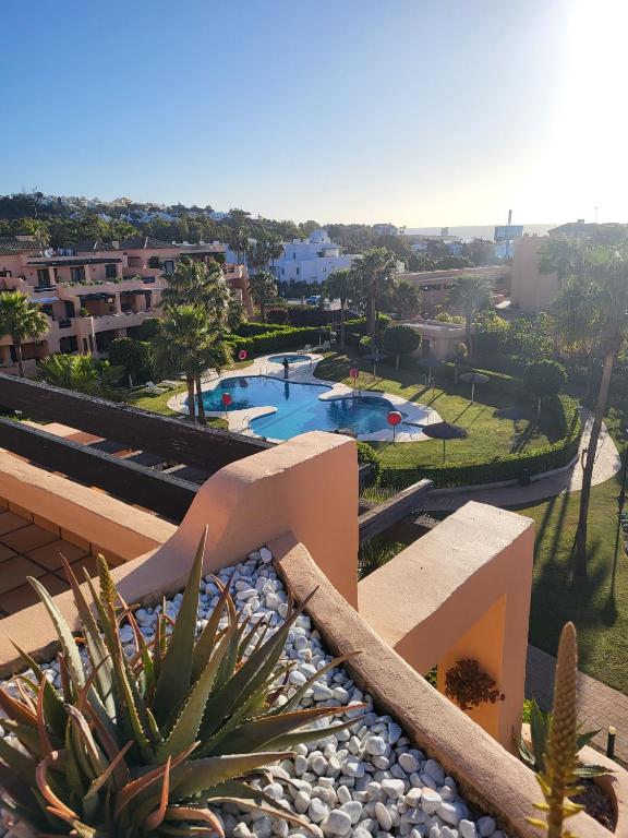 a view of a resort with a swimming pool and buildings at Casares Beach luxe penthouse in Casares