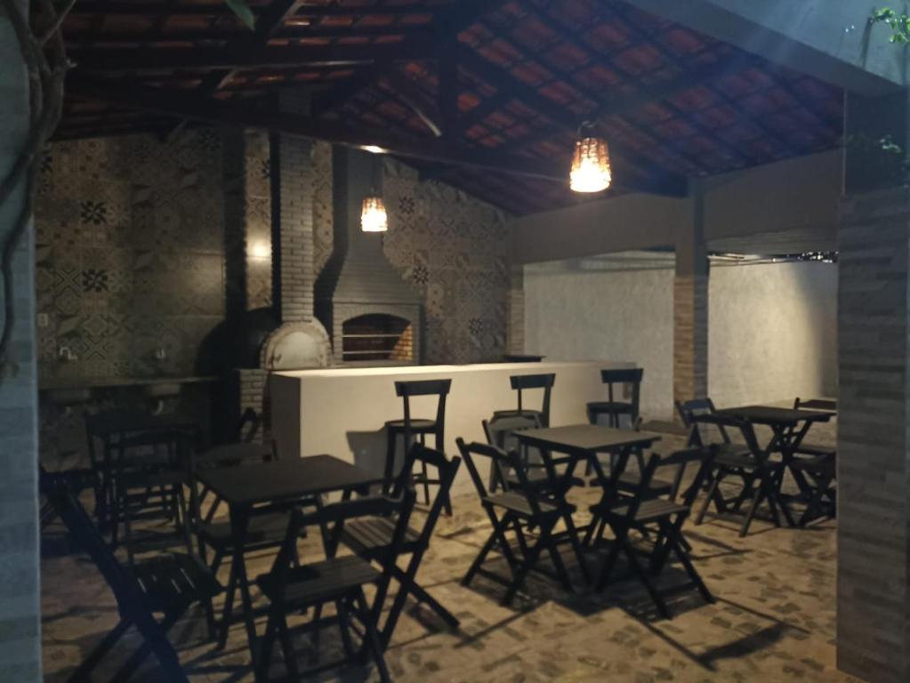 a group of tables and chairs in a room at Casa Carlotta in Paracuru