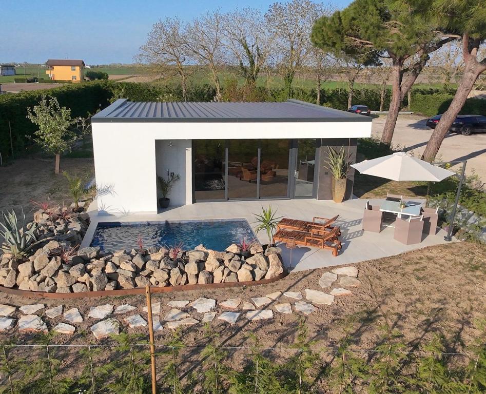 a small house with a fire pit in front of it at The K Noir Private Pool Luxury Suite in Civé