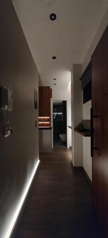 a hallway leading to a kitchen with lights on the wall at Celestial Luxury SKG Port in Thessaloniki