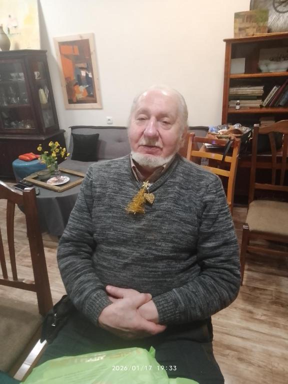 a man sitting in a chair with his arms crossed at Hotel in Tbilisi City