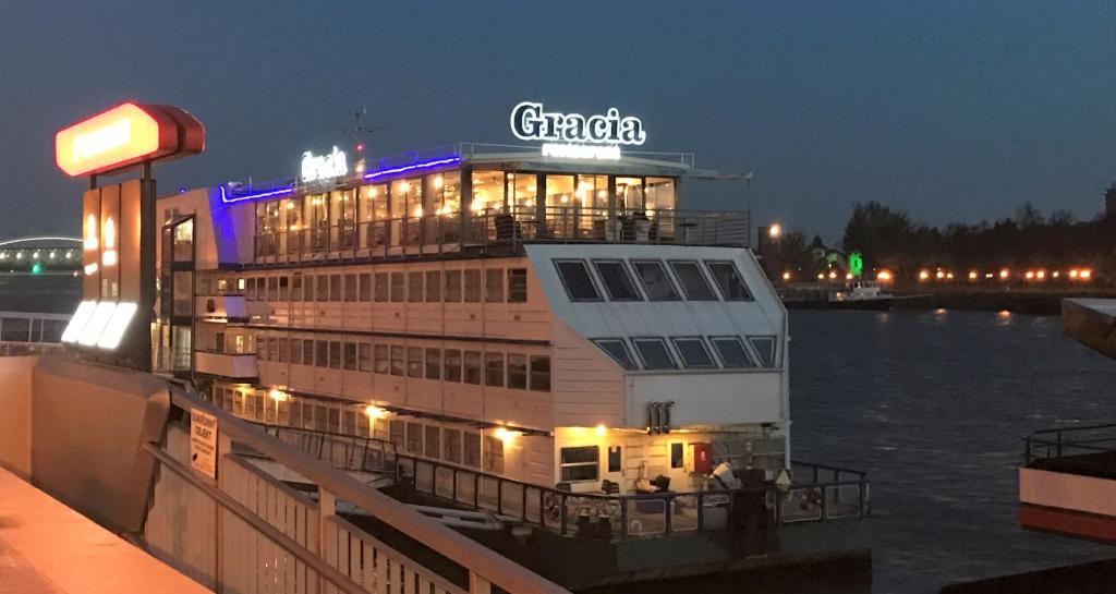 a cruise ship on the water at night at Botel Gracia in Bratislava