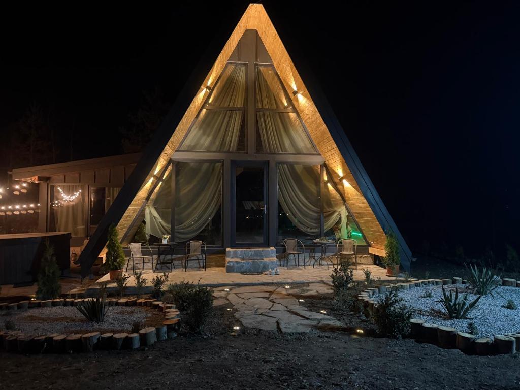 a large tent with chairs and lights at night at Cabana A Vic in Taşca
