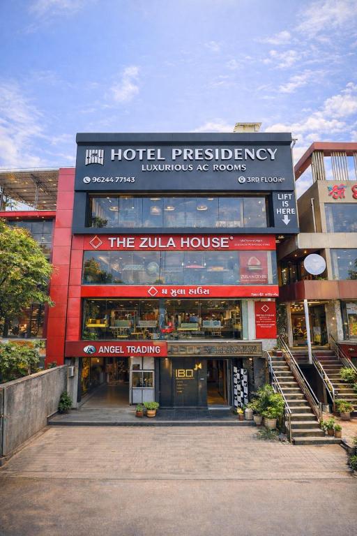 a building with a zula house in a city at Hotel Presidency - Sosyo Circle in Surat