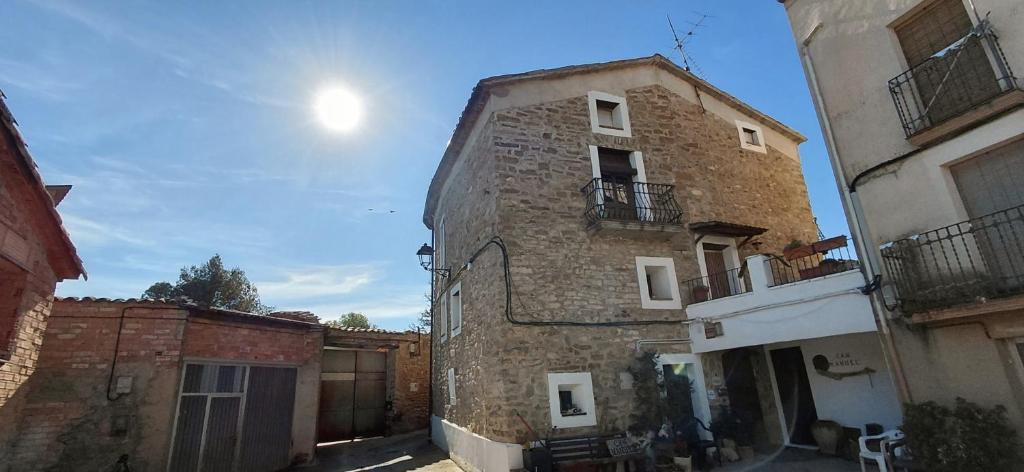 an old stone building in an alley with a fence at Can Manuel in Gabet