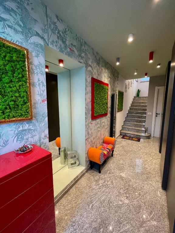 a living room with an orange chair and stairs at Casa CLEO in Domodossola