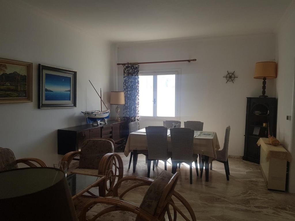 a dining room with a table and chairs at Nautilus andros house in Andros