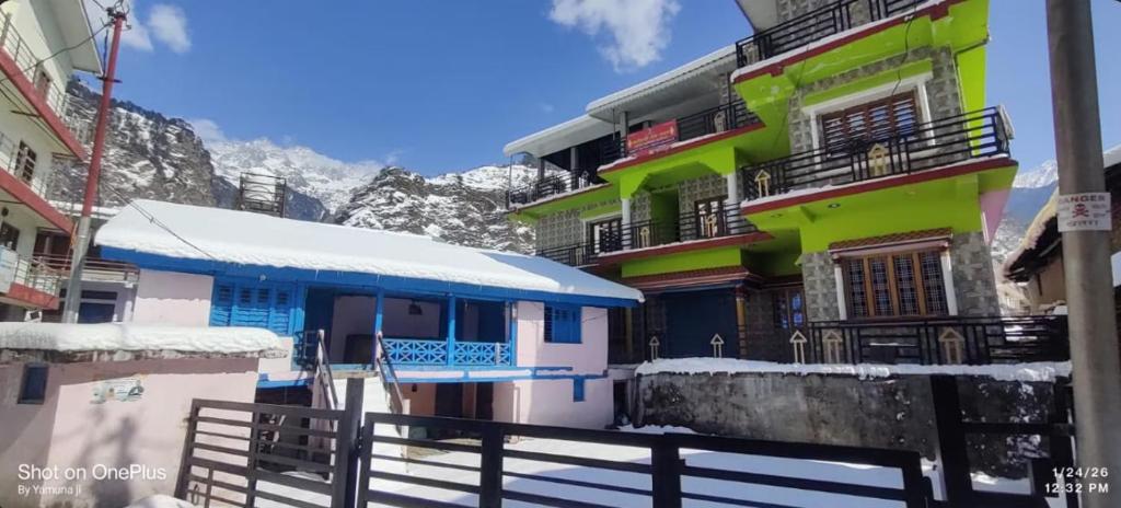 a group of buildings with snow on them at Omji Niwas - Kalindi in Kharsālī
