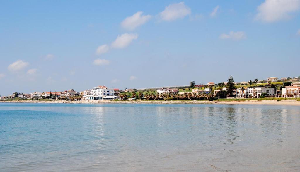 un grande bacino d’acqua con case sullo sfondo di Hotel Acquamarina a Donnalucata