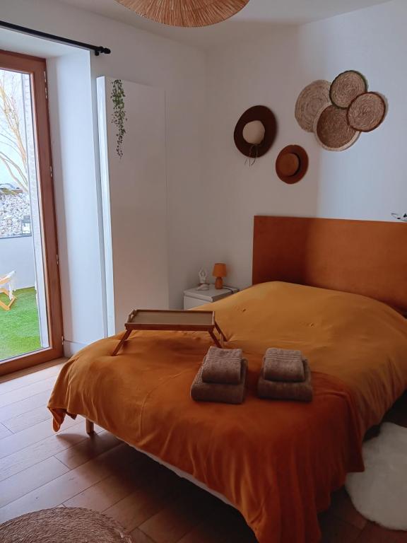 a bedroom with a bed with two towels on it at Le refuge des deux âmes in Alby