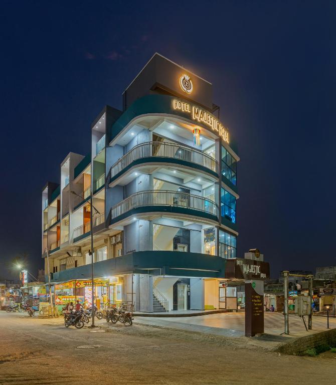 a building with a sign on it at night at Majestic Royal by Travel Pleasure Hotels in Akalkot