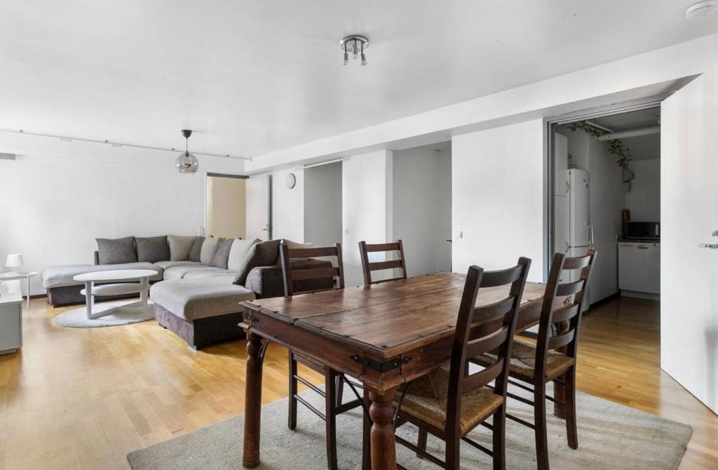 a living room with a table and chairs and a couch at 2 bedrooms 1 bathroom kitchen apartment in Stockholm