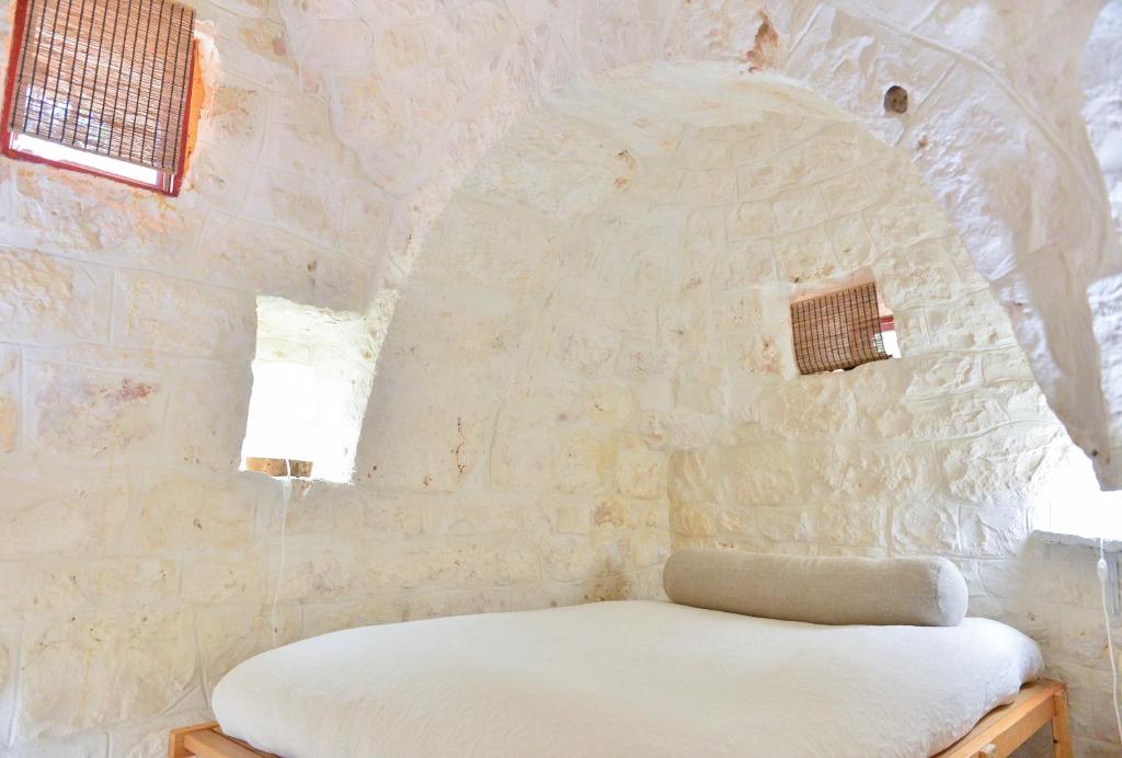 A bed or beds in a room at Trullo L'alcova