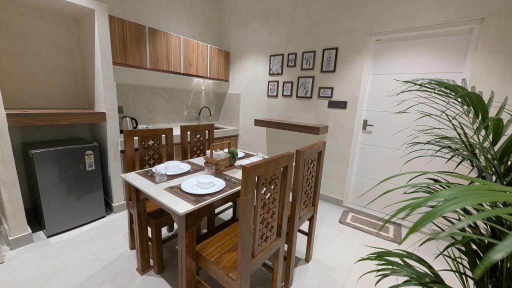 a kitchen with a table and chairs in a room at Prime Suites in Varkala