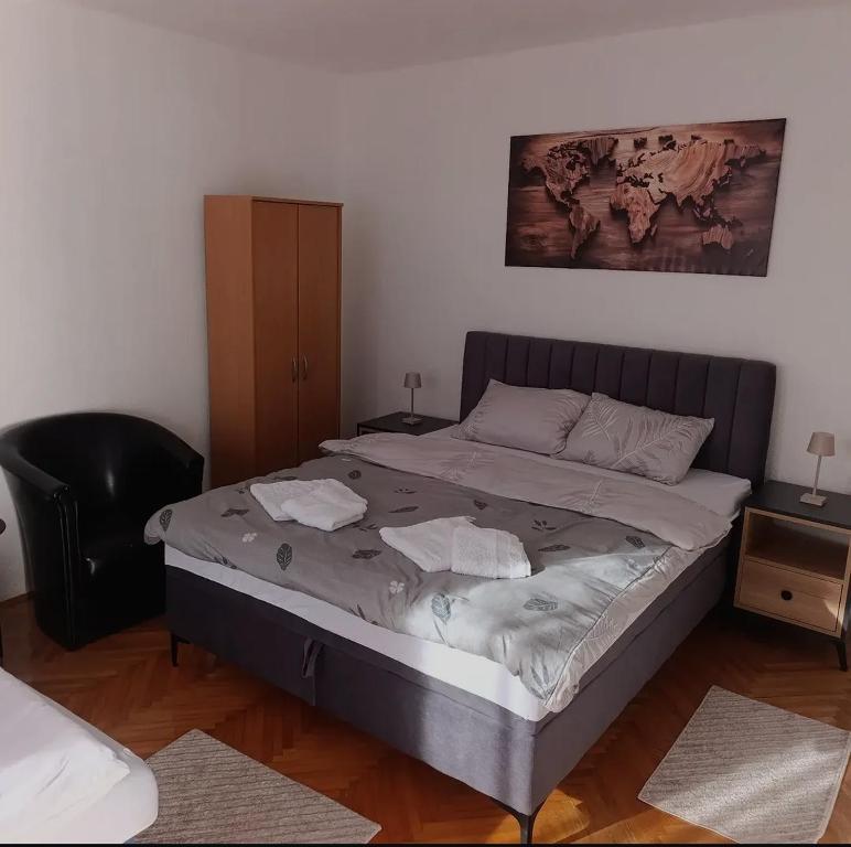 a bedroom with a large bed with towels on it at MiYo STAY in Žitkovac