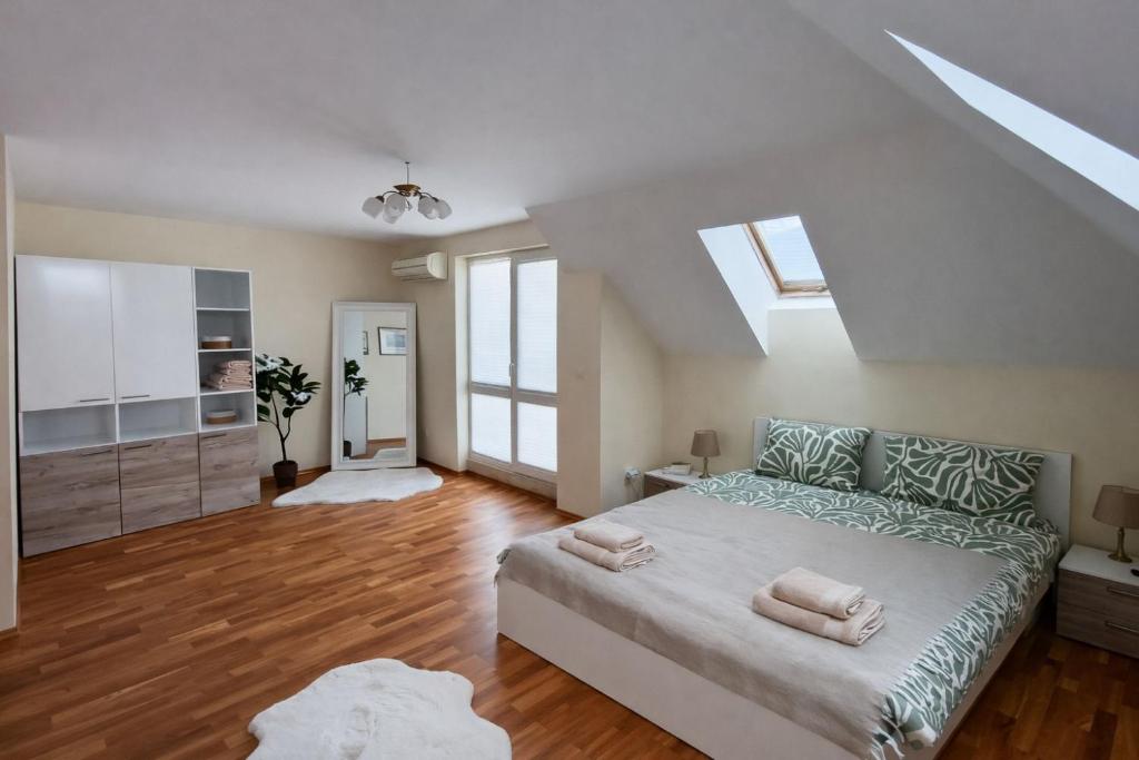 a bedroom with a large bed with two pillows on it at River Park Oasis apartment in Sandanski
