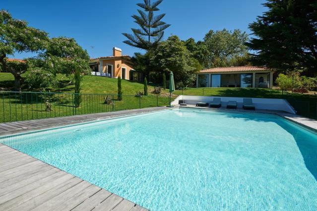 una piscina en un patio con una casa en Villa Rio Seco en Sintra