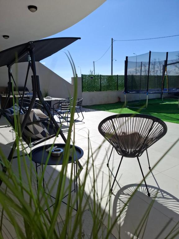 a group of chairs and tables on a patio at KEFI House in Pondolívadhon