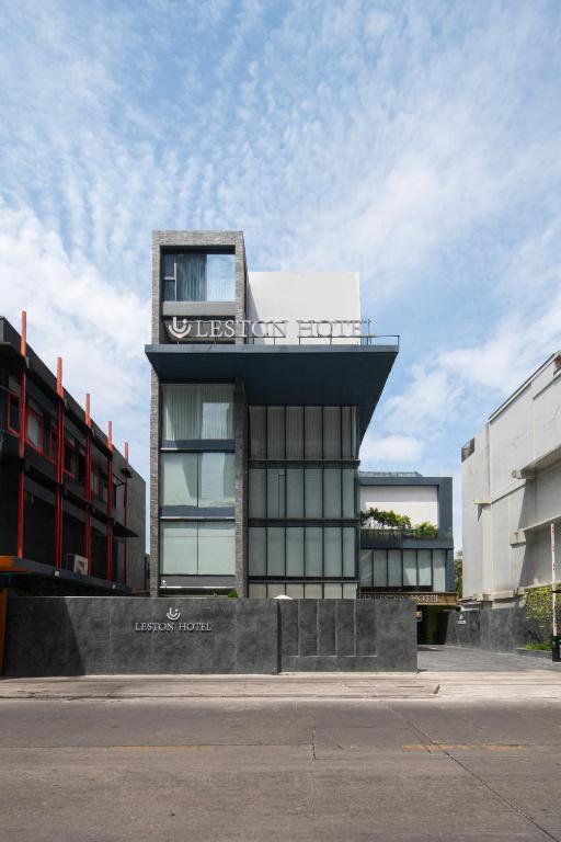 a building with a sign on the side of it at Leston Hotel in Bangkok