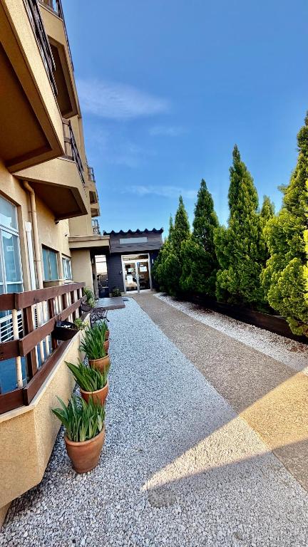 a house with potted plants on the side of it at Tabist International Hotel Kaike in Yonago