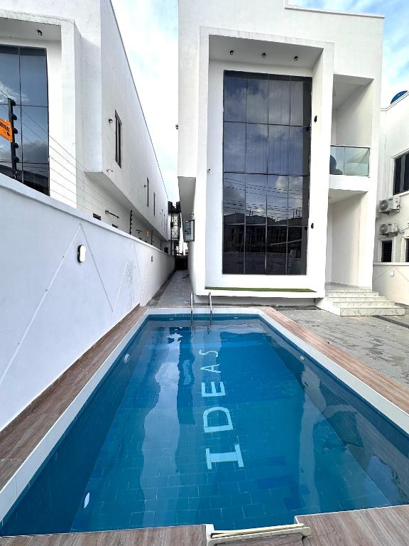 a swimming pool in the middle of a house at Tranquil Residences - Orchid, Lekki in Lekki