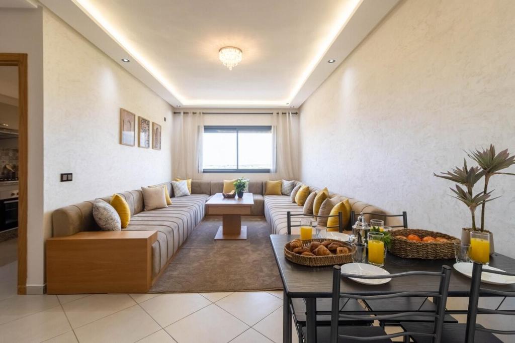 a living room with a couch and a table at Blue Waves 2 Bedrooms with Pool in Bouznika