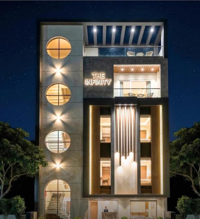 a building with the university sign on it at night at The Infinity Hotel in Kānpur