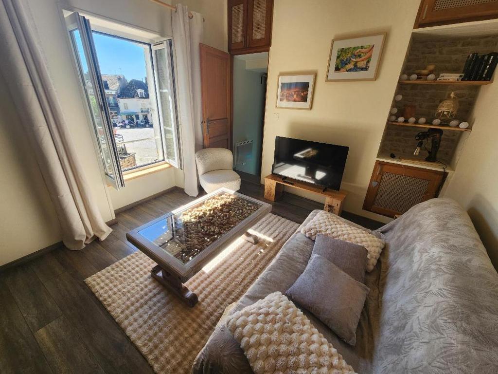 a living room with a couch and a table at Cœur de Toucy in Toucy