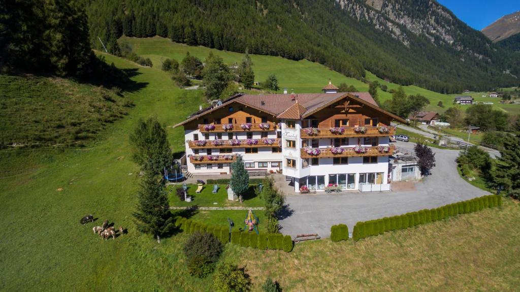 an aerial view of a large building on a hill at Hotel Kaserhof in Valles