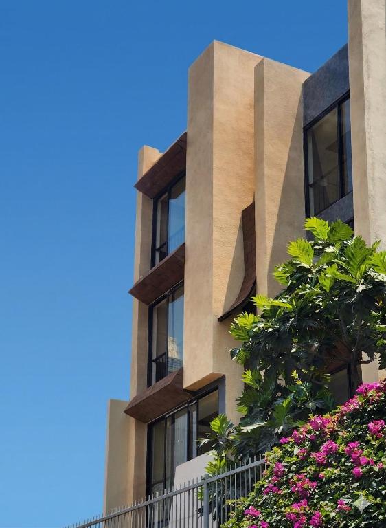 a building with flowers in front of it at REFUEL NEST Boutique Hotel in Danang