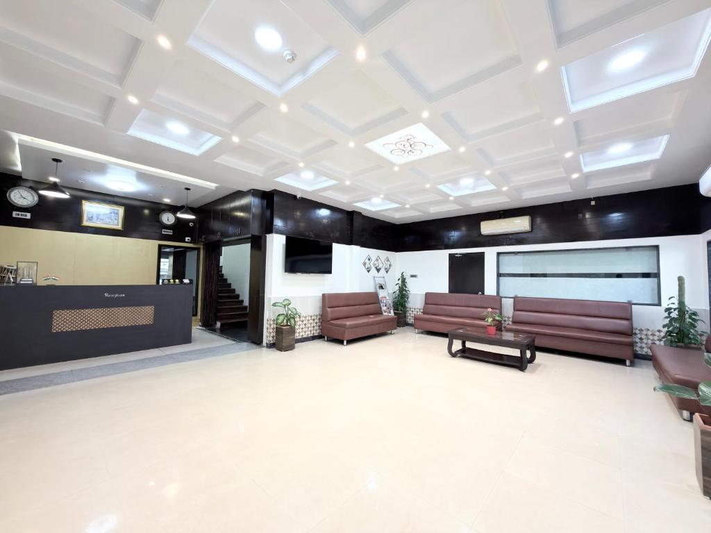 a lobby with couches and a stage in a building at Malaysia inn in Chennai