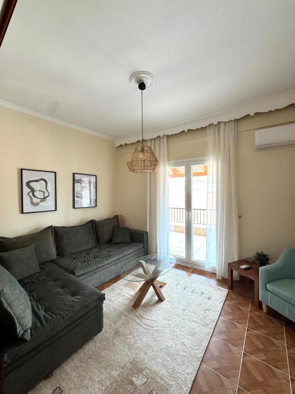 a living room with a couch and a table at Dina Apartment in Ágios Rókkos