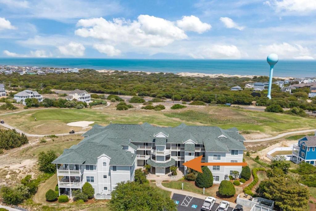 an aerial view of a house with the ocean in the background at Wicked Fun at Windswept Ridge in Corolla