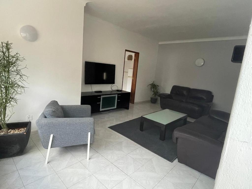 a living room with a couch and a tv at Large 2 bedroom Lagos apartment in Lagos