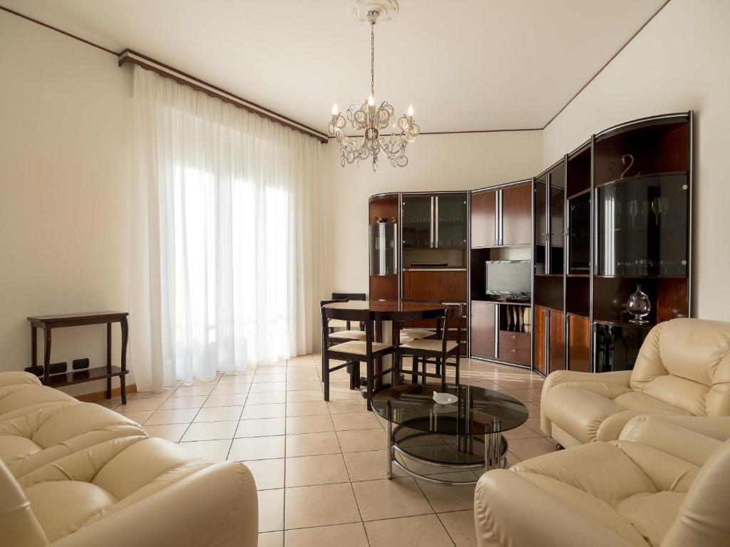 a living room with couches and a dining room at Antonio Rooms 2 in Parma