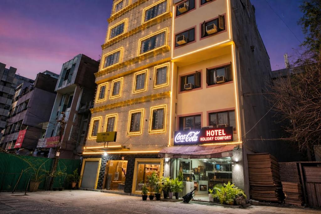a tall building with a sign in front of it at Hotel Holiday Comfort - 800 mts from Jallianwala Bagh in Amritsar