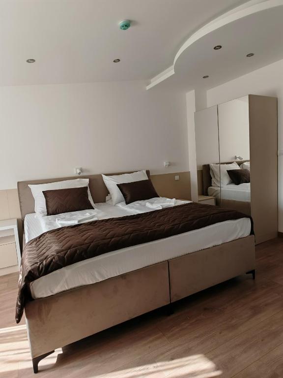 a bedroom with a large bed in a room at Motel Adut Boleč in Donja Kapija