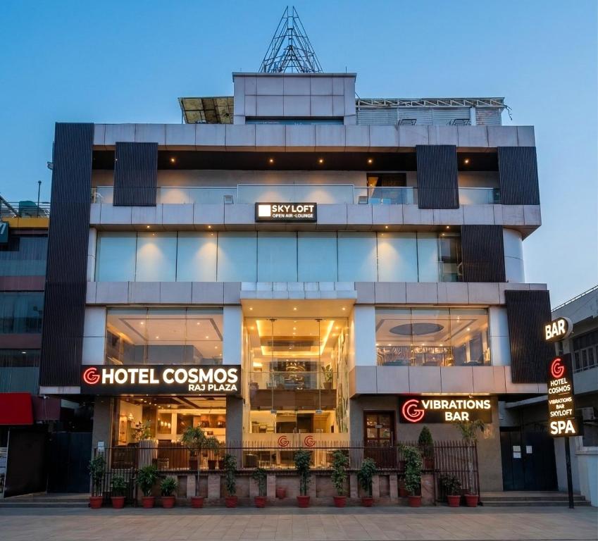 a building with a hotel cosmopolis sign in front of it at Cosmos Raj Plaza Jaipur in Jaipur
