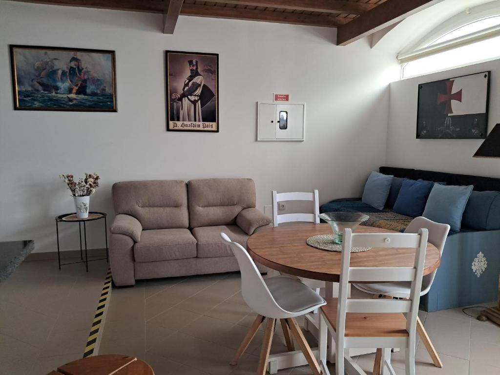 a living room with a table and a couch at Casa do Mestre in Tomar