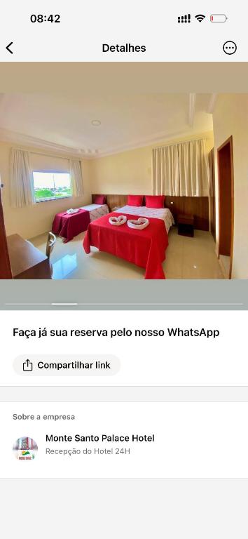 a bedroom with two beds and a red blanket at Monte Santo palace hotel in Monte Santo