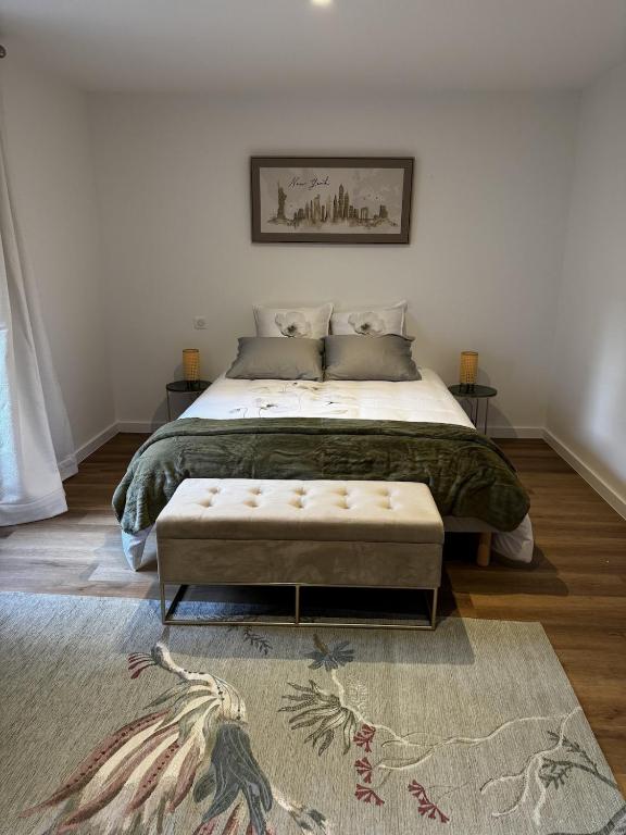 a bedroom with a large bed and a rug at Le Chevalier I - L'Écrin Alsacien in Sélestat