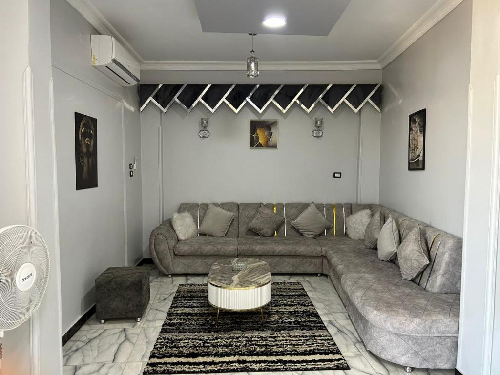 a living room with a couch and a table at Fatah apartment 12 in Luxor