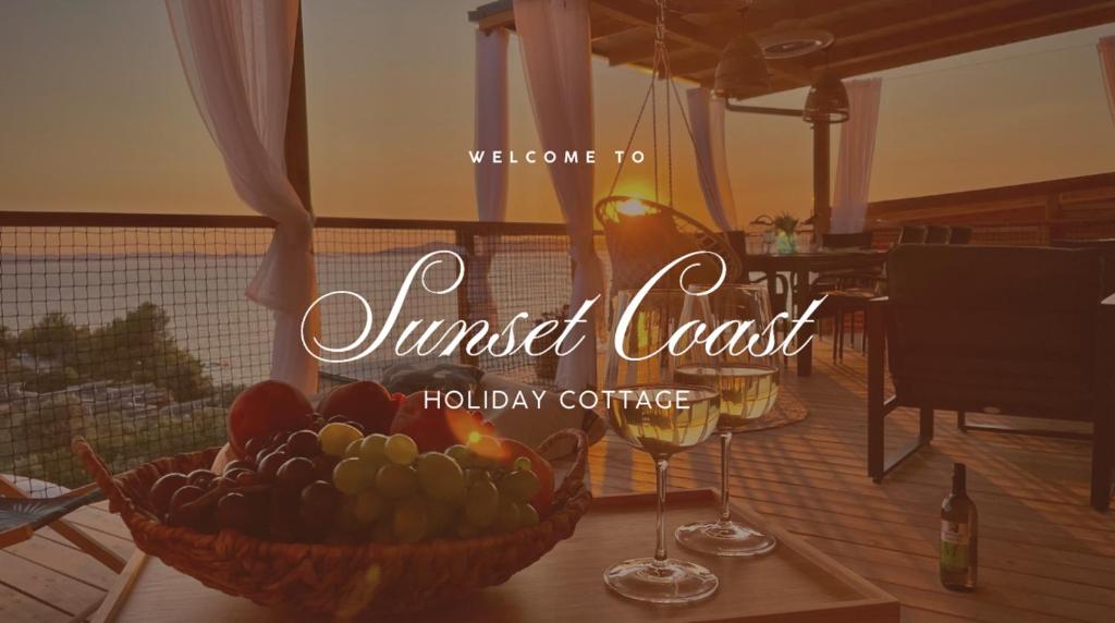a bowl of fruit and two glasses of wine at Sunset Coast - Paradise Cottage in Drage