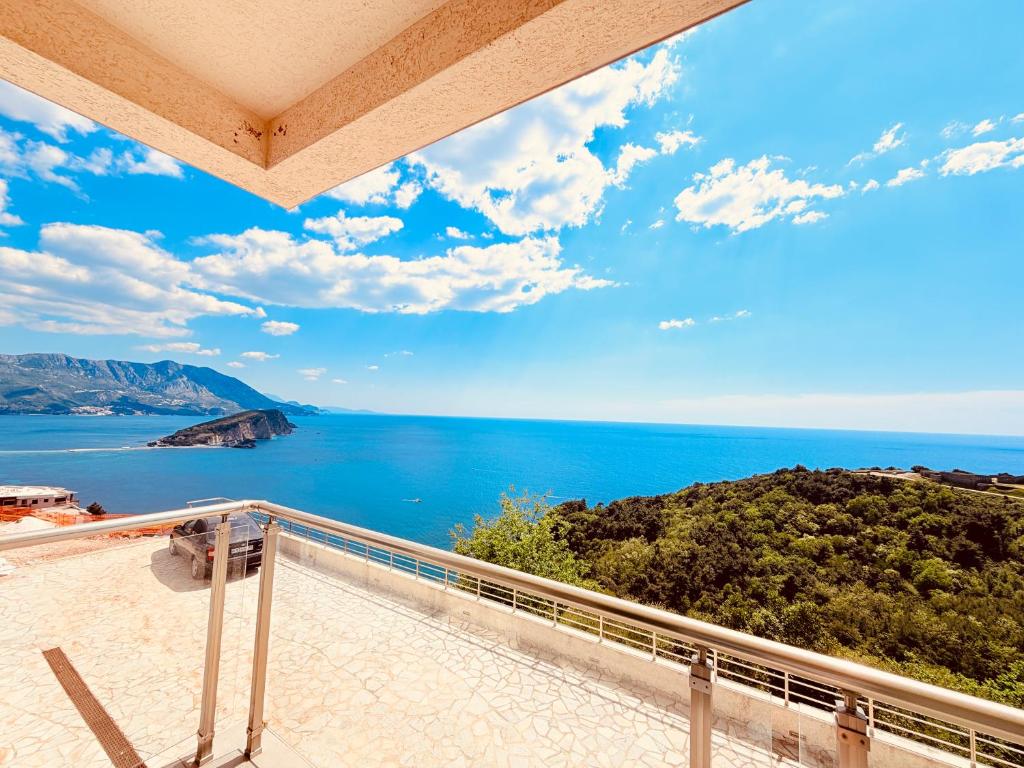 a view of the ocean from the balcony of a house at Hillside Apartment with Sea View in Budva
