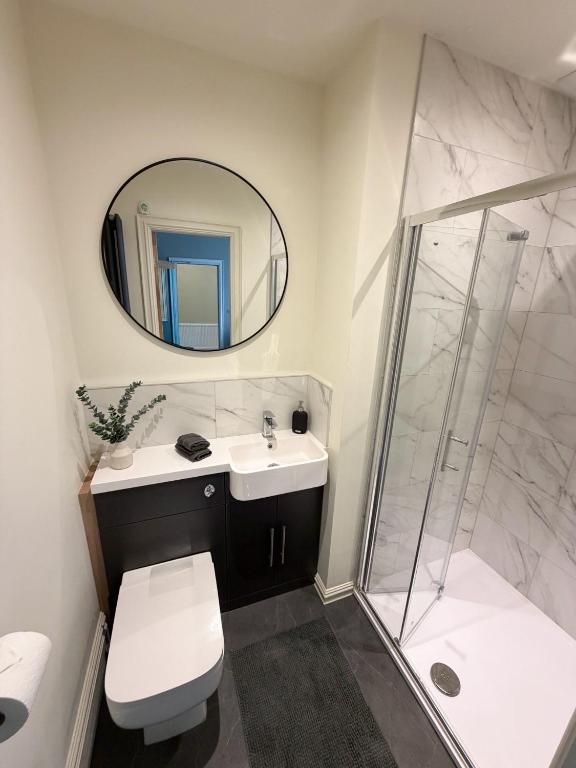 a bathroom with a toilet and a sink and a shower at 4 James street in Selby