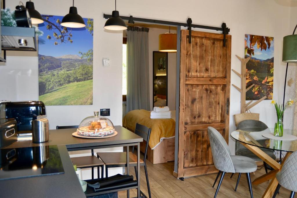 a room with a bed and a table and chairs at Matilde House in Fanano