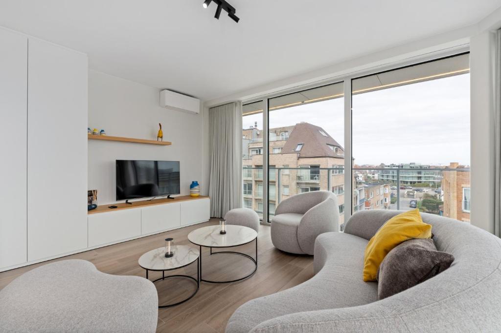a living room with two couches and a tv at Baldus 0401 P47 in Sint-Idesbald