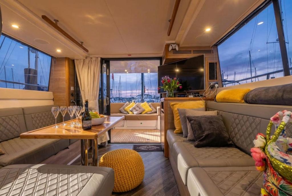 a room with a couch and a bed and a table at 2BR Heated Yacht, Lymington Centre, Beautiful View in Lymington