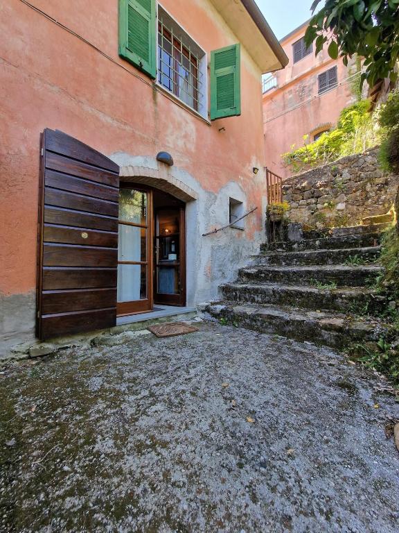 a building with a door and stairs in front of it at Le Coccinelle in Pallerone