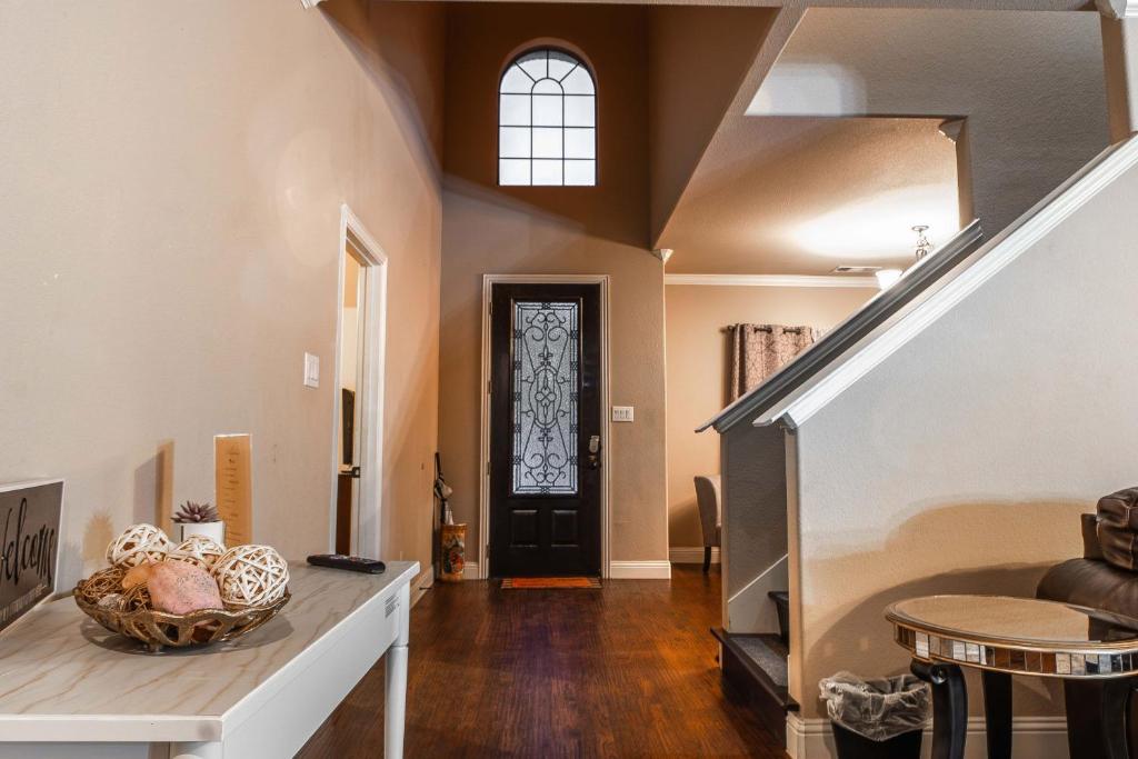 a hallway with a black door and a stair case at Osile Villa in DeSoto